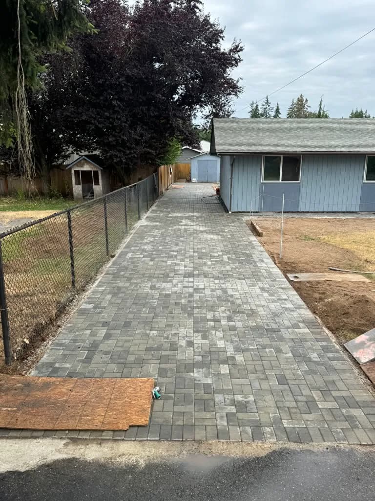 Long brick paver driveway walkway