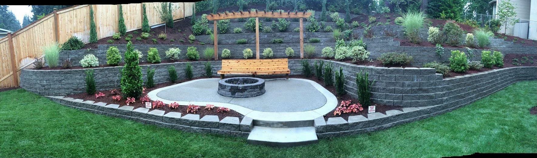 Terraced retaining wall system with pergola